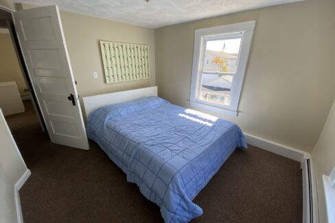 a bed sitting in a bedroom next to a window.