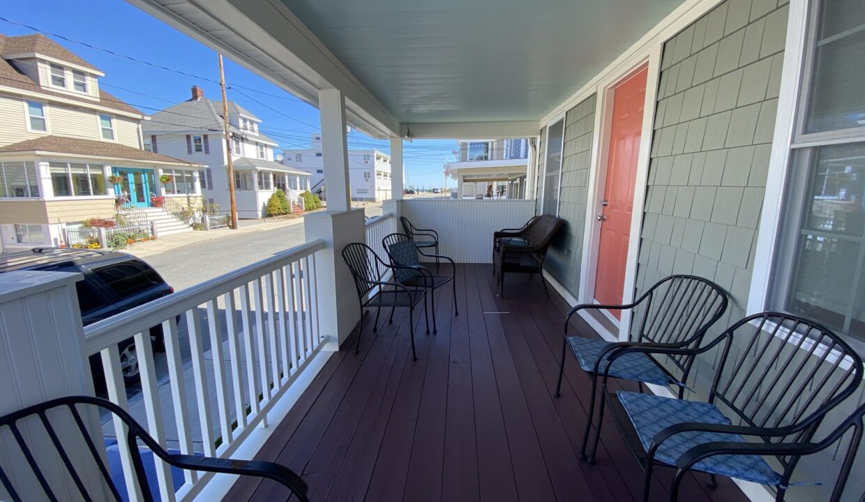 a couple of chairs that are on a porch.