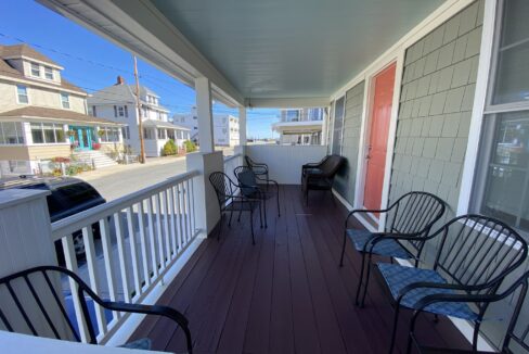 a couple of chairs that are on a porch.