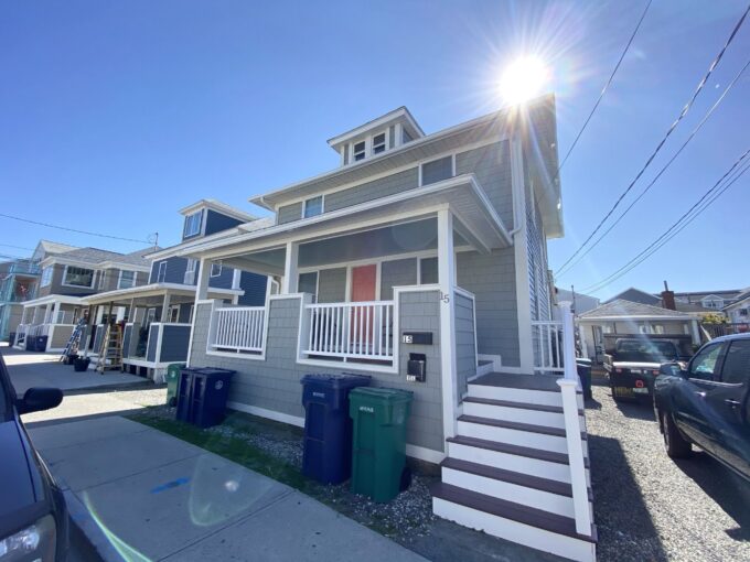 a row of houses with a car parked in front of them.