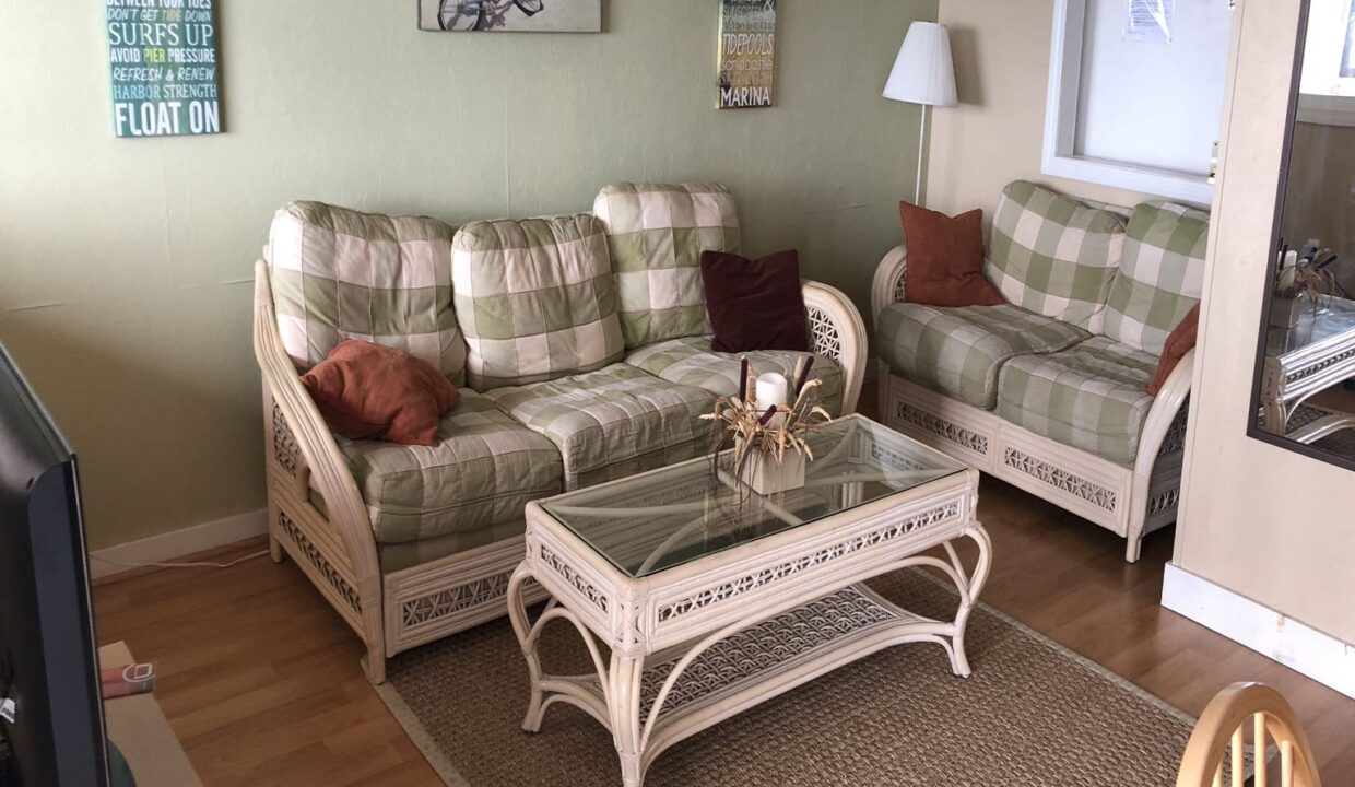 a living room filled with furniture and a flat screen tv.