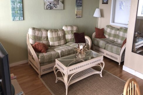 a living room filled with furniture and a flat screen tv.