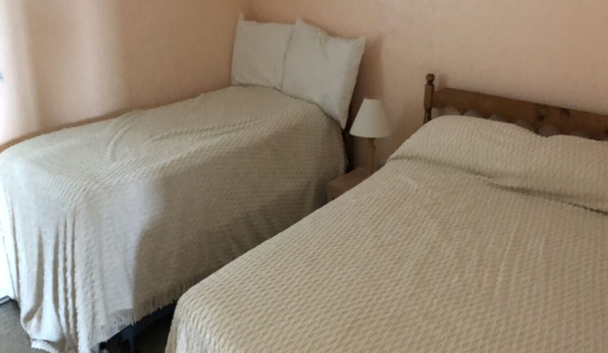 a couple of beds sitting next to each other in a bedroom.