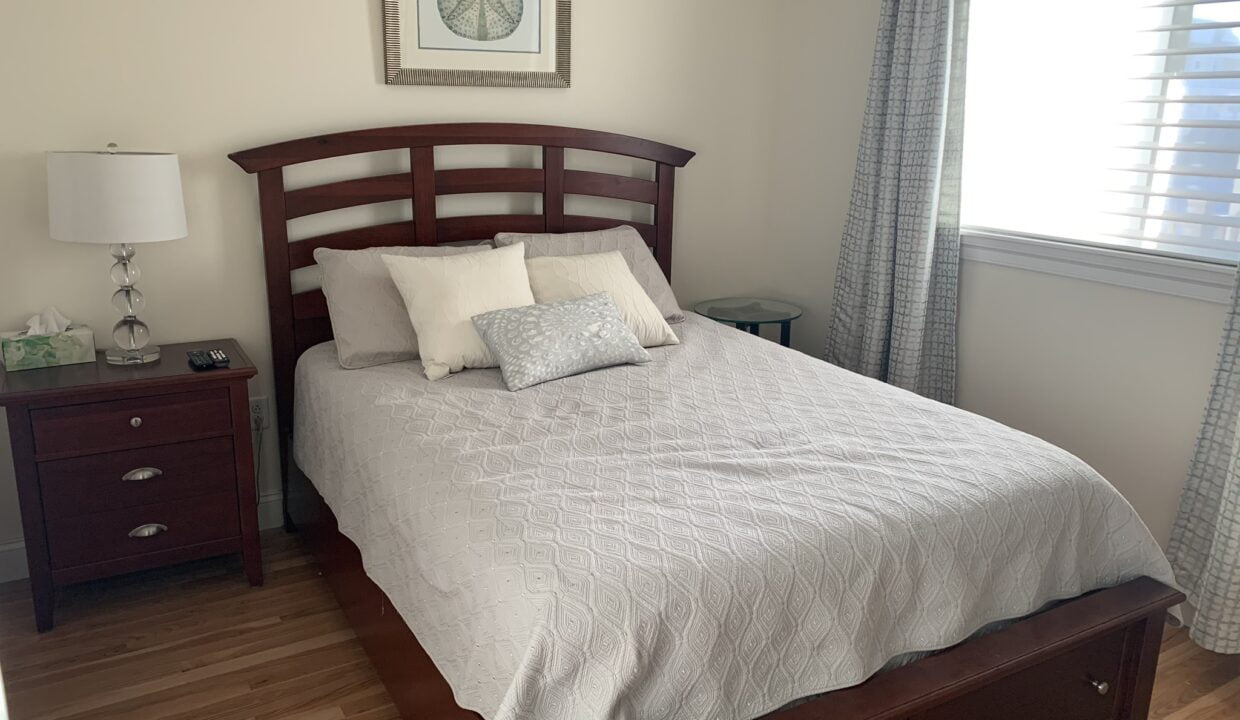 a bed sitting in a bedroom next to a window.