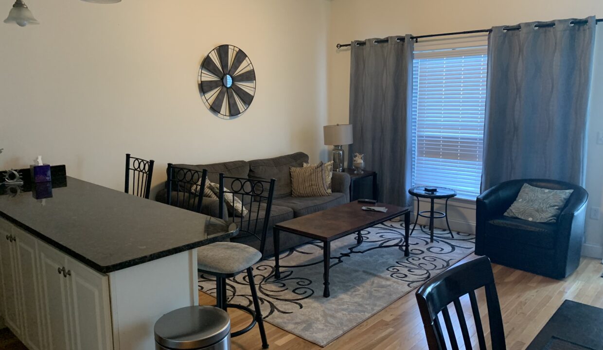 a living room filled with furniture and a center island.