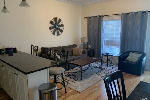 a living room filled with furniture and a center island.