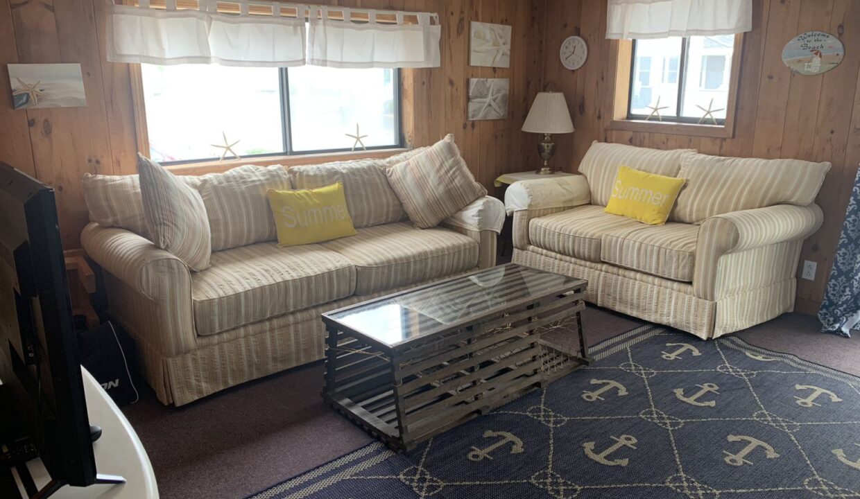 a living room with two couches and a coffee table.