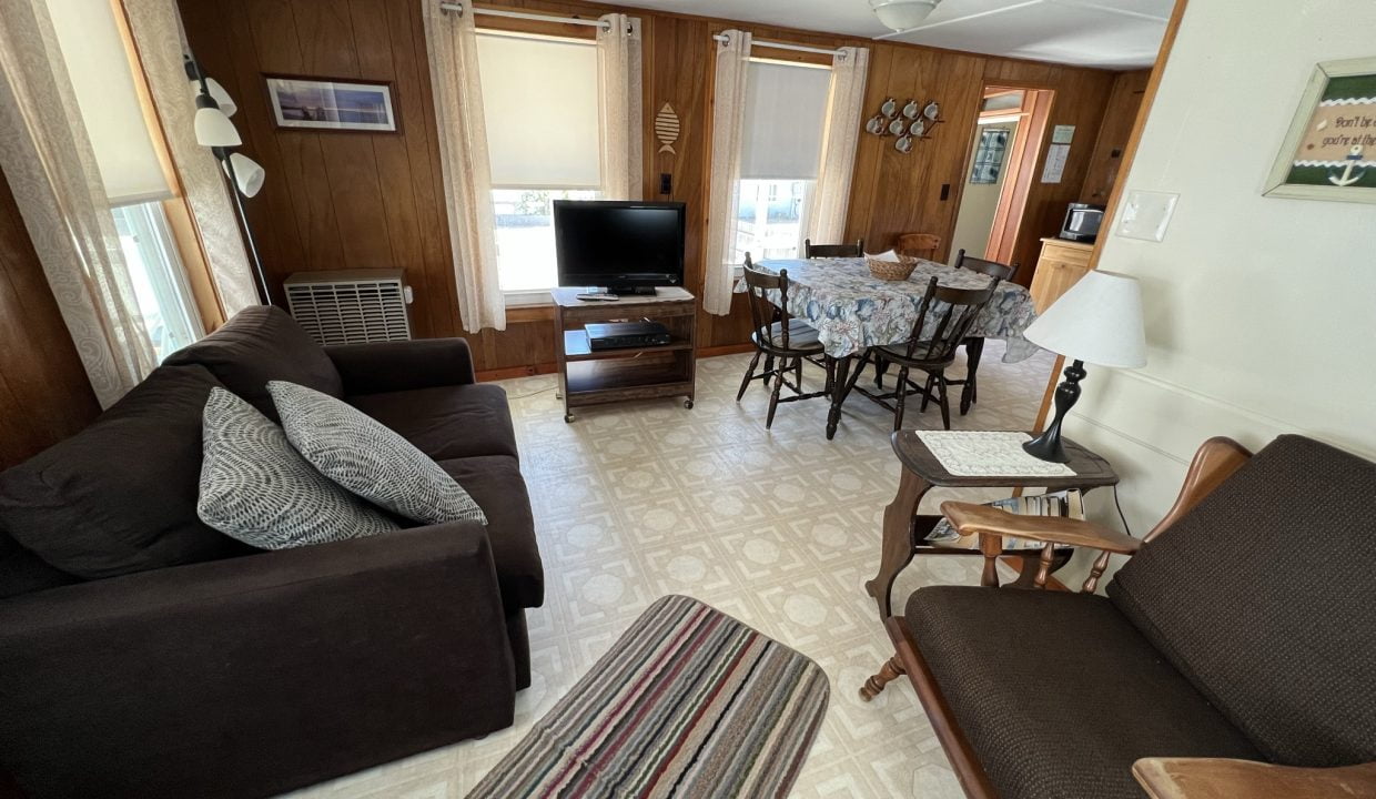 a living room filled with furniture and a flat screen tv.