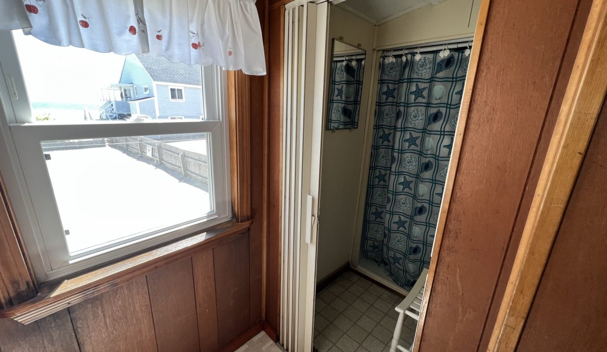 a bathroom with a shower and a window.