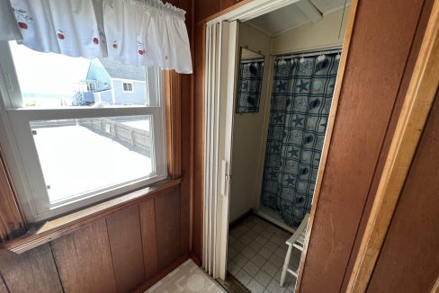 a bathroom with a shower and a window.