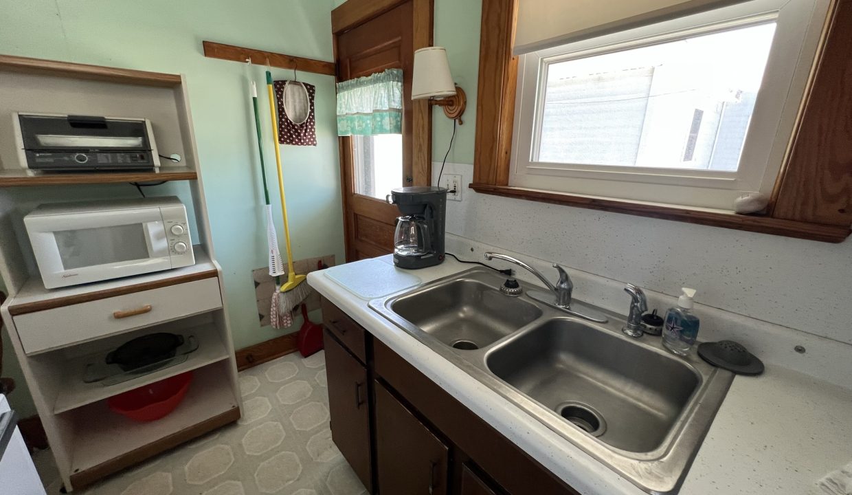 a kitchen with a sink and a microwave.