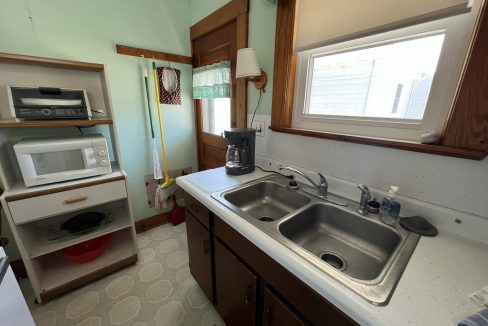 a kitchen with a sink and a microwave.