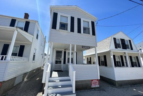 a couple of white houses sitting next to each other.