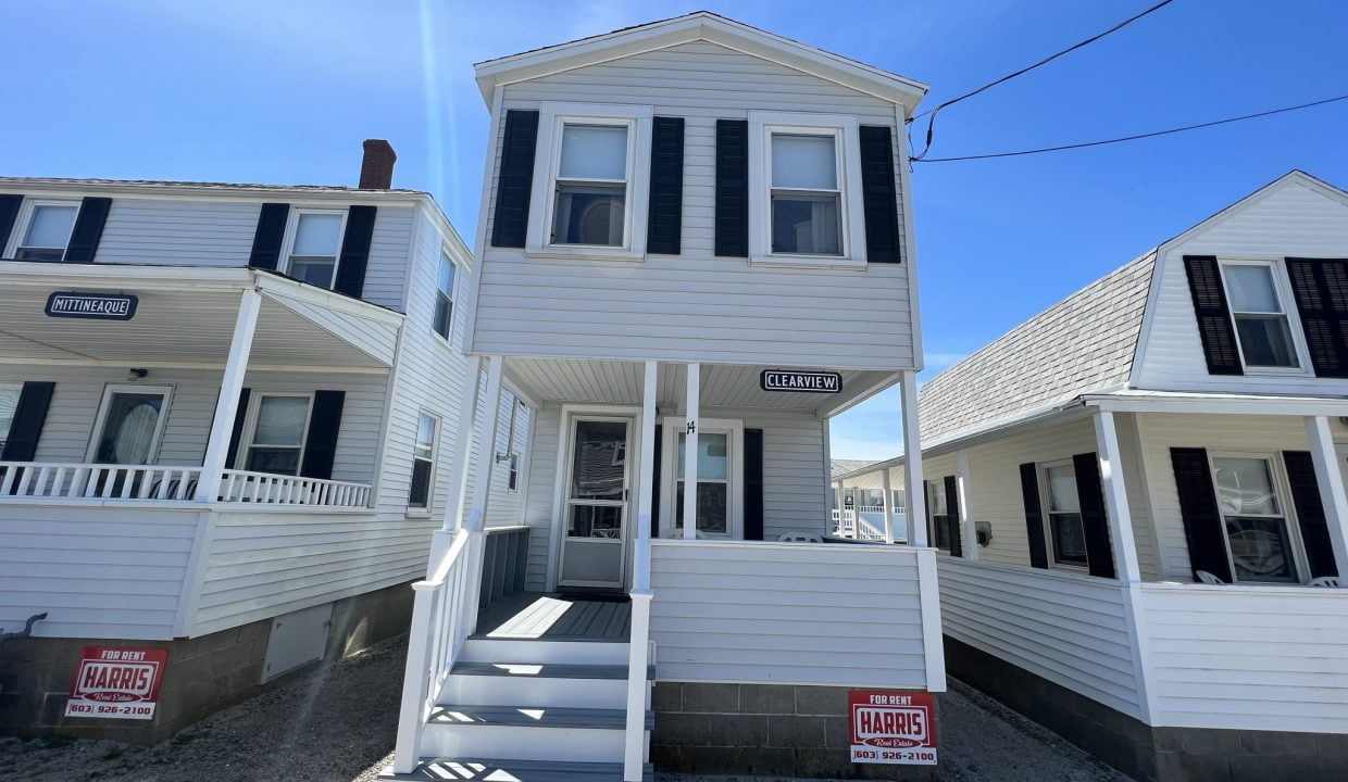 a couple of white houses sitting next to each other.