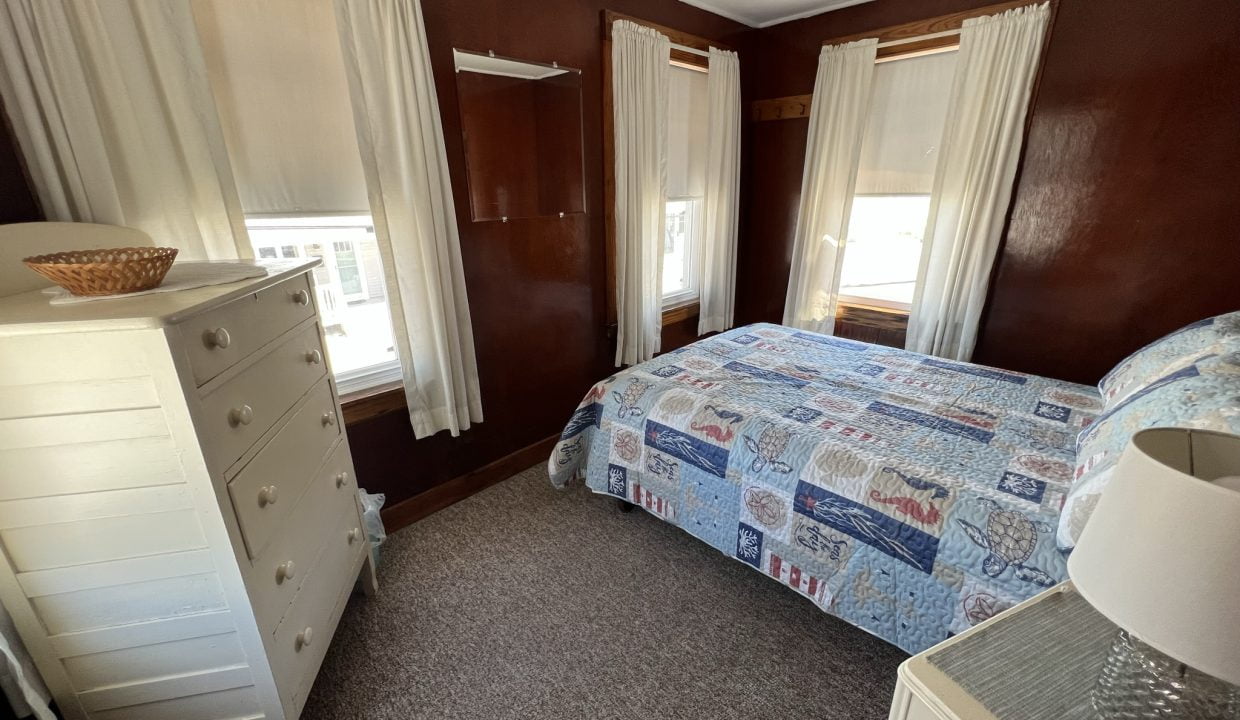 a bedroom with a bed and a dresser.