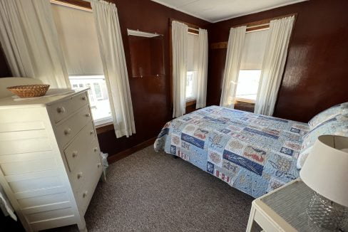 a bedroom with a bed and a dresser.