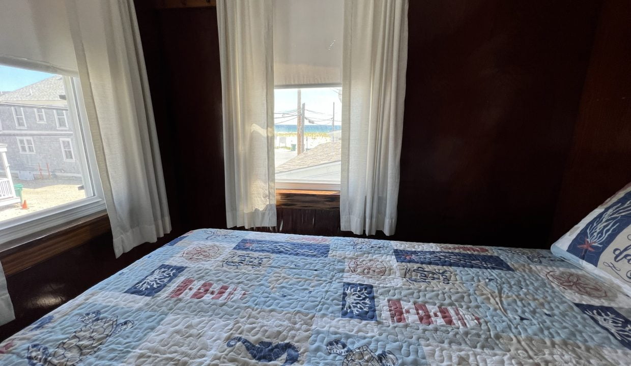 a bed sitting in a bedroom next to a window.