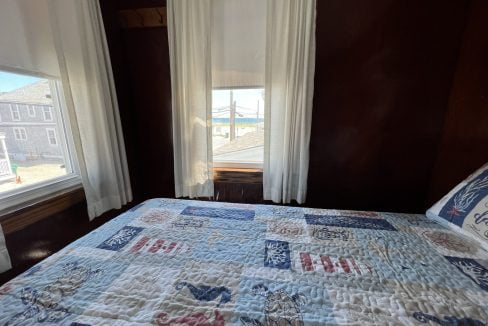 a bed sitting in a bedroom next to a window.