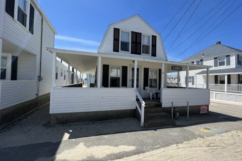 a couple of white houses sitting next to each other.