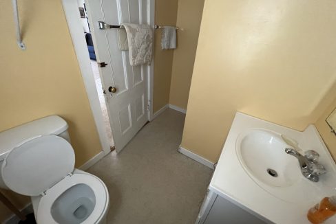 a white toilet sitting next to a white sink.