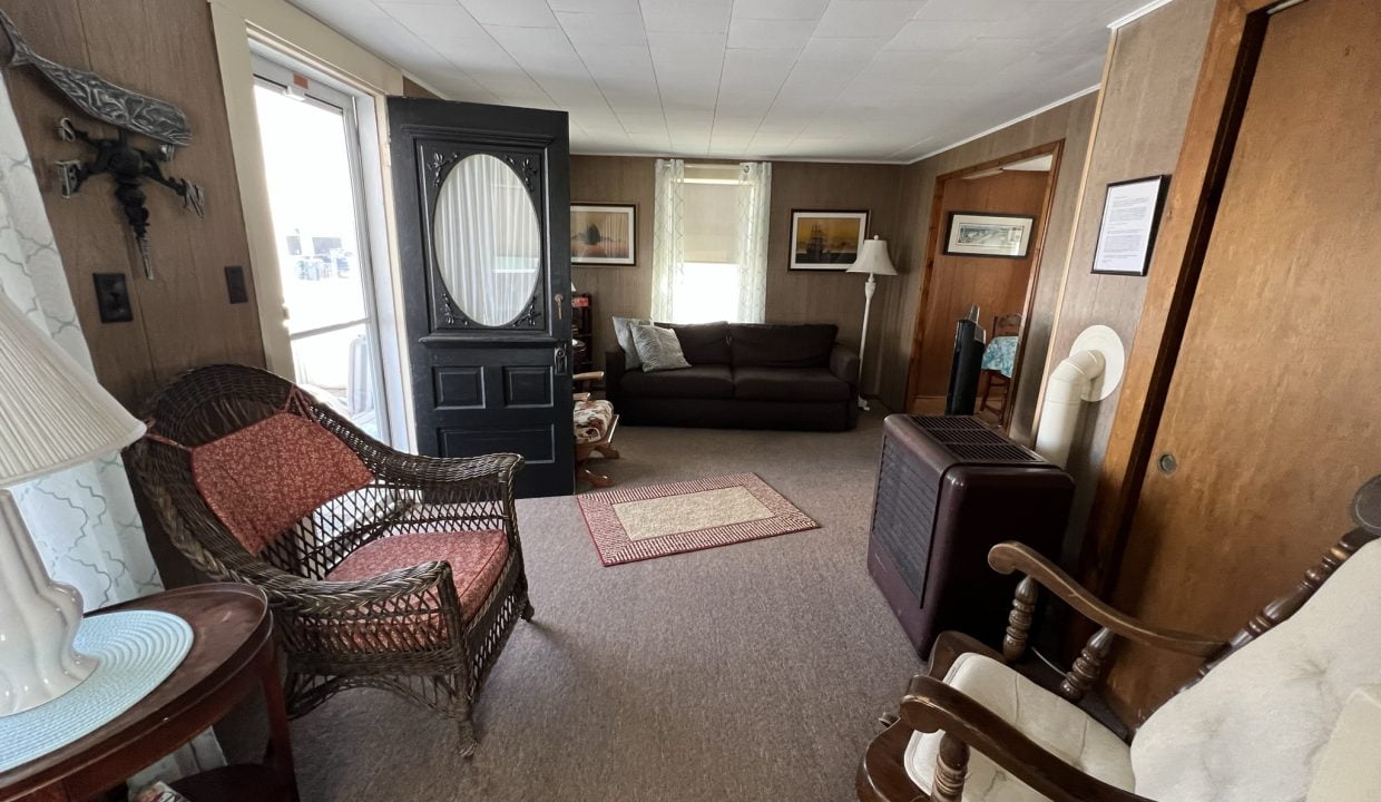 a living room filled with furniture and a doorway.