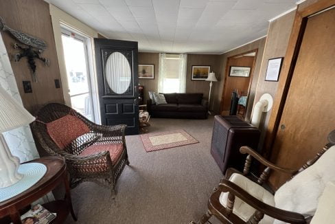 a living room filled with furniture and a doorway.