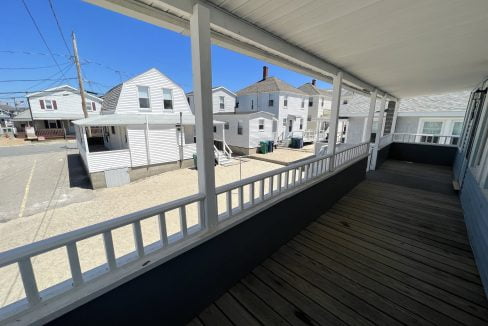 a porch with a view of a row of houses.