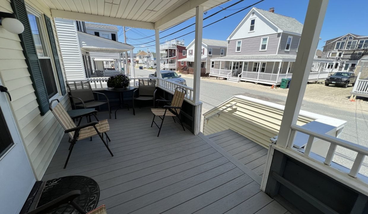 a porch with chairs and a television on it.