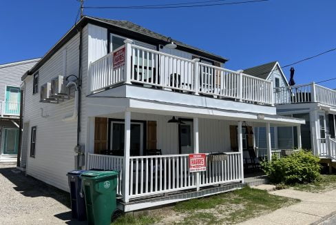 a two story house with a balcony and balconies.