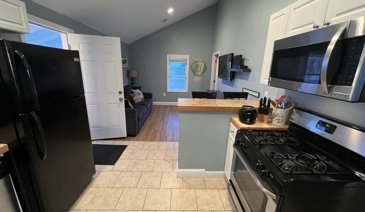 a kitchen with black appliances and white cabinets.