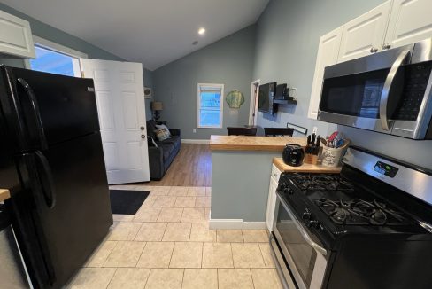 a kitchen with black appliances and white cabinets.