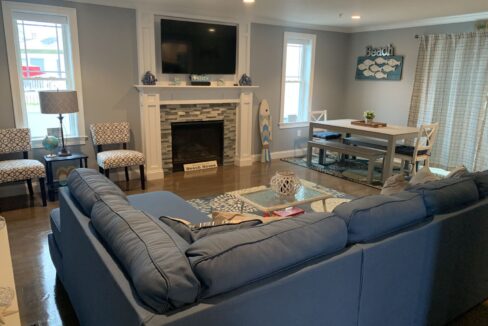 a living room filled with furniture and a fire place.