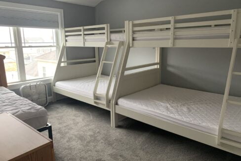 a bedroom with bunk beds and a window.