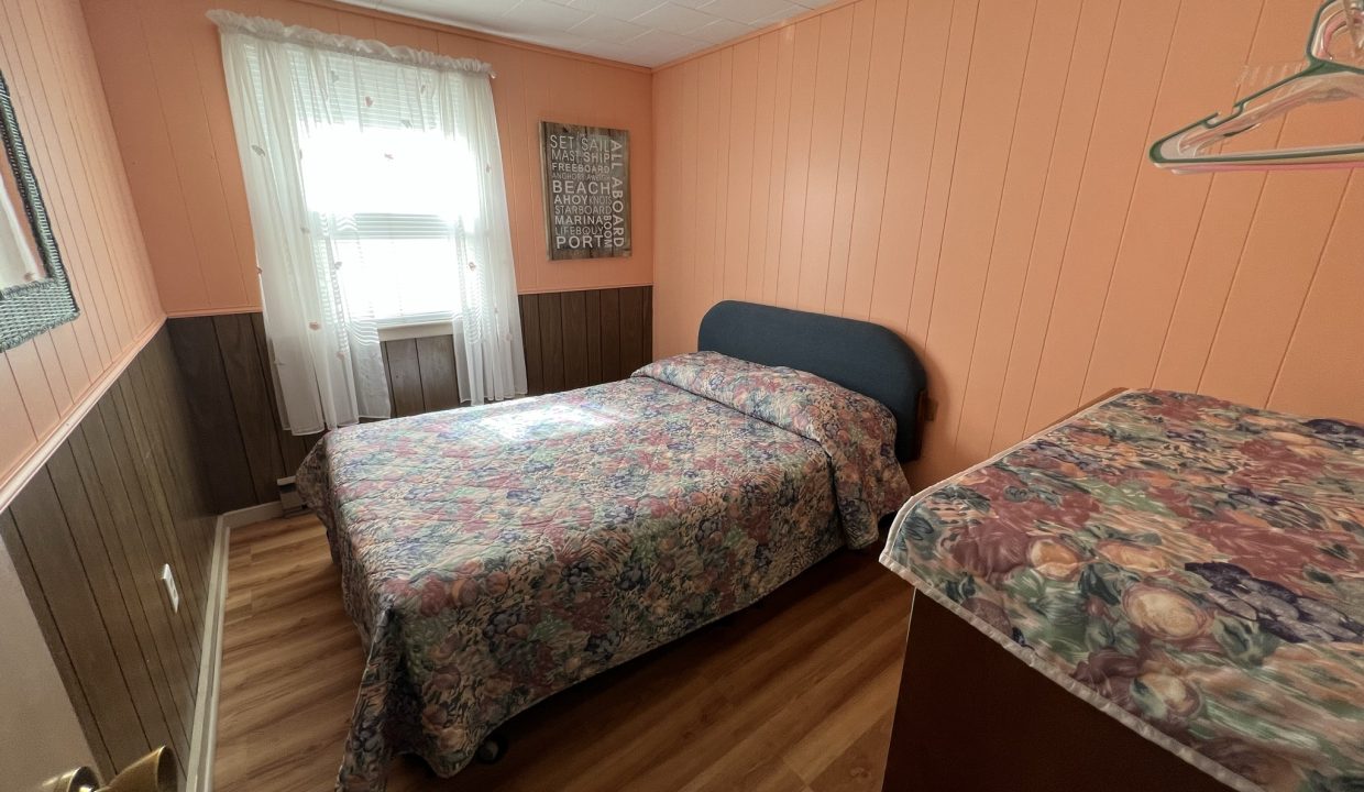 a bedroom with a bed and a window.