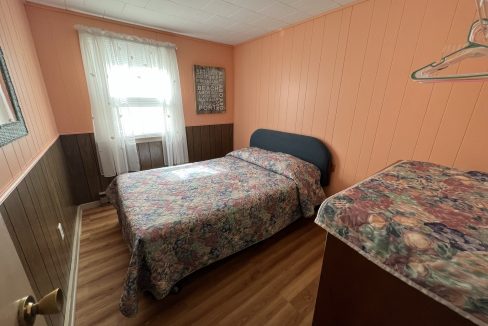 a bedroom with a bed and a window.