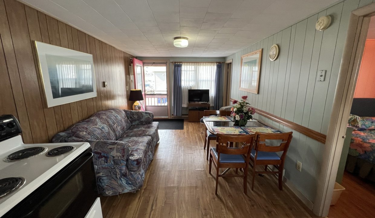 a living room with a couch a table and a stove.