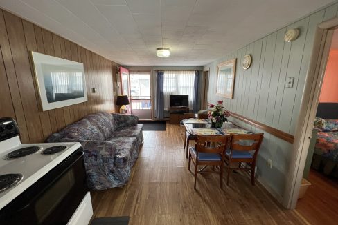 a living room with a couch a table and a stove.