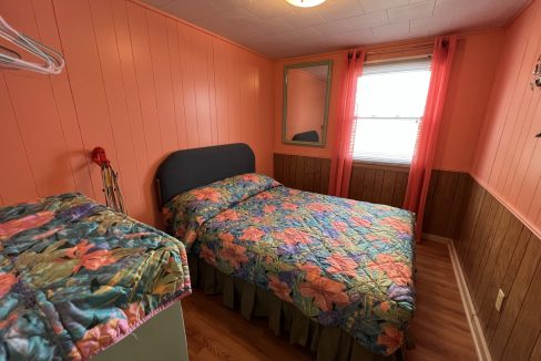 a bed room with two beds and a window.