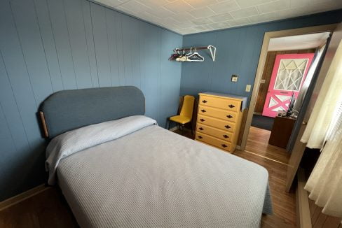 a bedroom with blue walls and a bed.