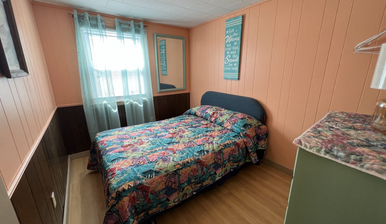 a bed sitting in a bedroom next to a window.