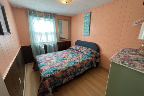 a bed sitting in a bedroom next to a window.