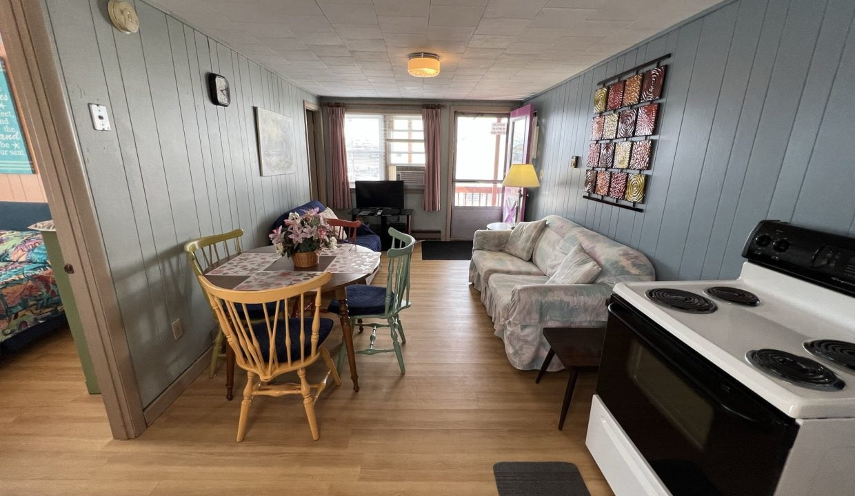 a kitchen and living room with wood floors.