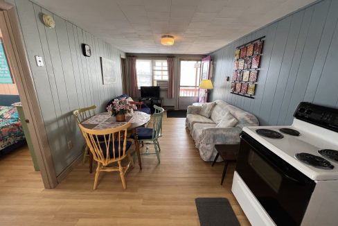 a kitchen and living room with wood floors.