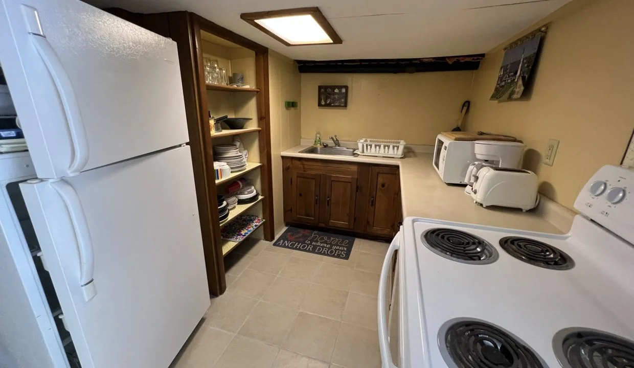 a kitchen with a refrigerator, stove, and sink.