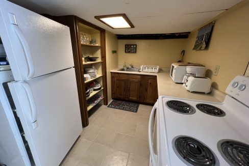 a kitchen with a refrigerator, stove, and sink.