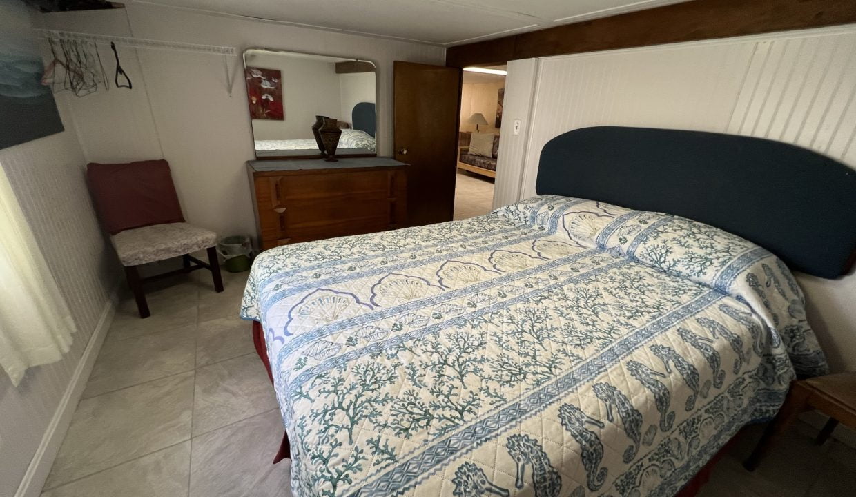 a bed sitting in a bedroom next to a dresser.