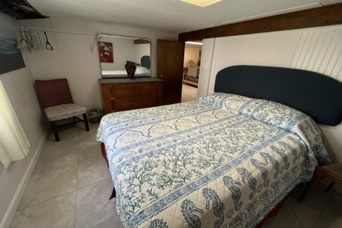 a bed sitting in a bedroom next to a dresser.