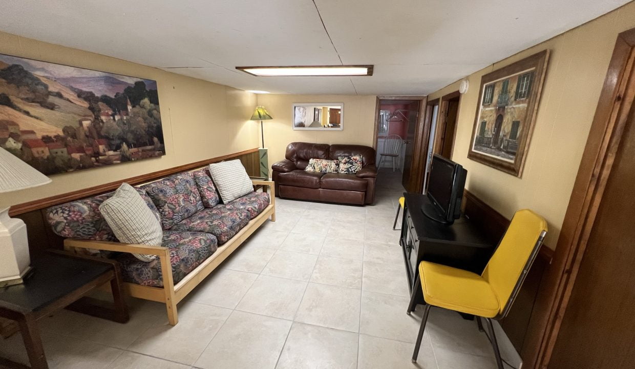 a living room filled with furniture and a flat screen tv.