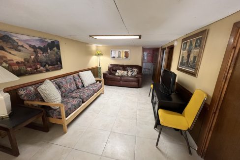 a living room filled with furniture and a flat screen tv.