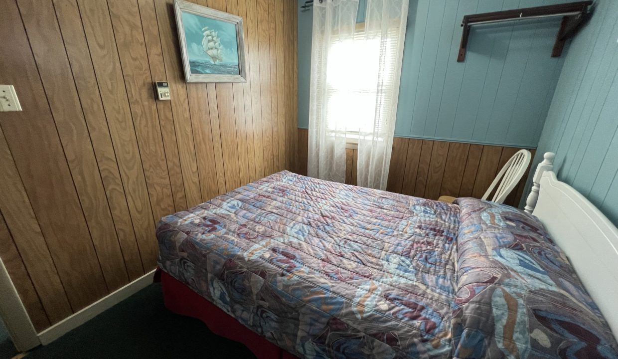 a bed sitting in a bedroom next to a window.